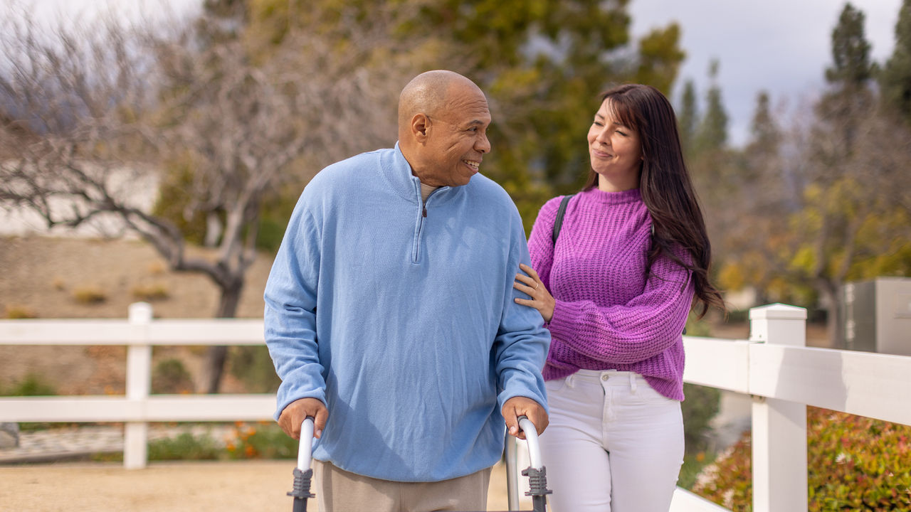 Man with walker walking at nursing home