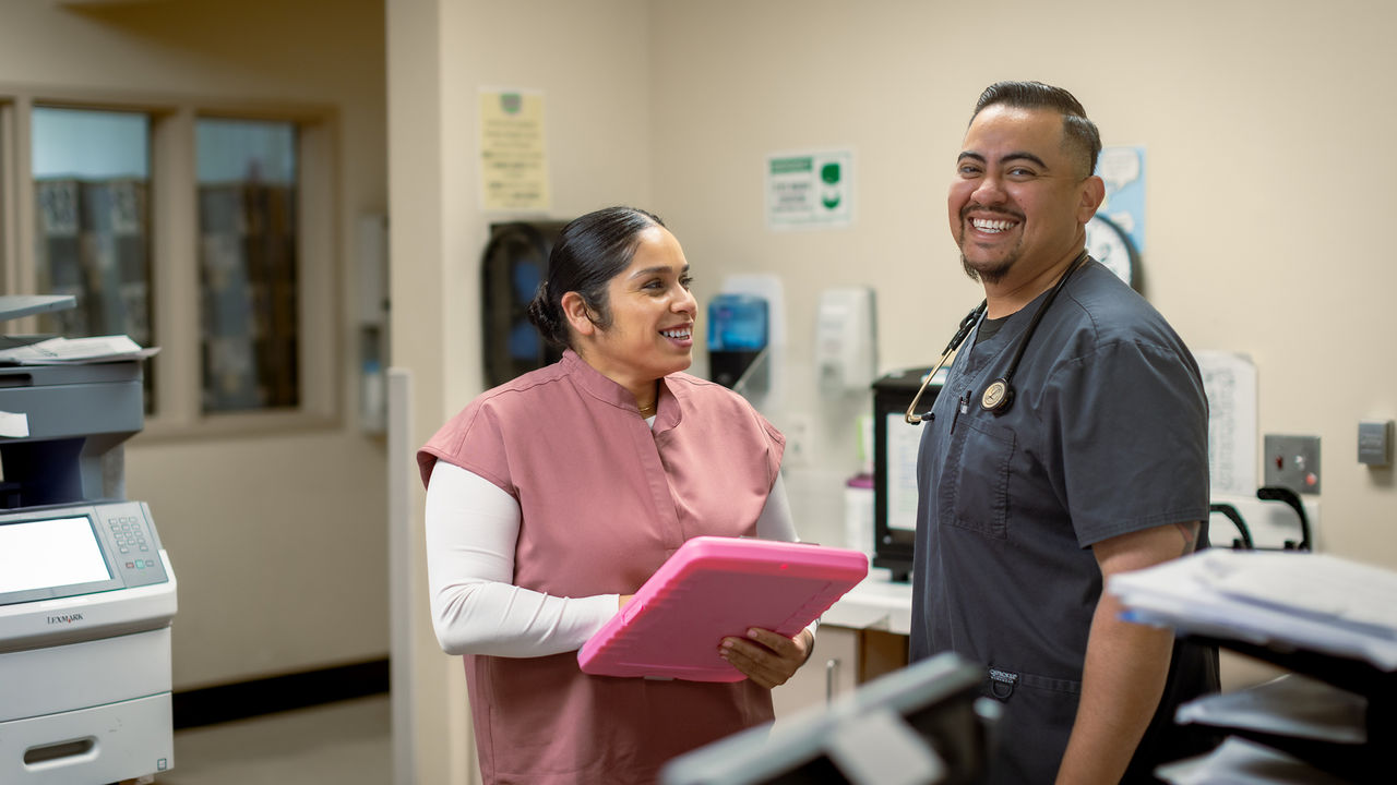 Two healthcare workers smiling together