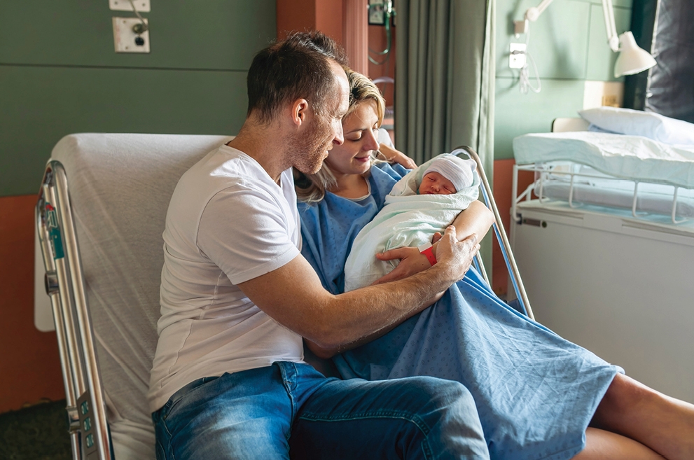 Mother and father holding newborn baby
